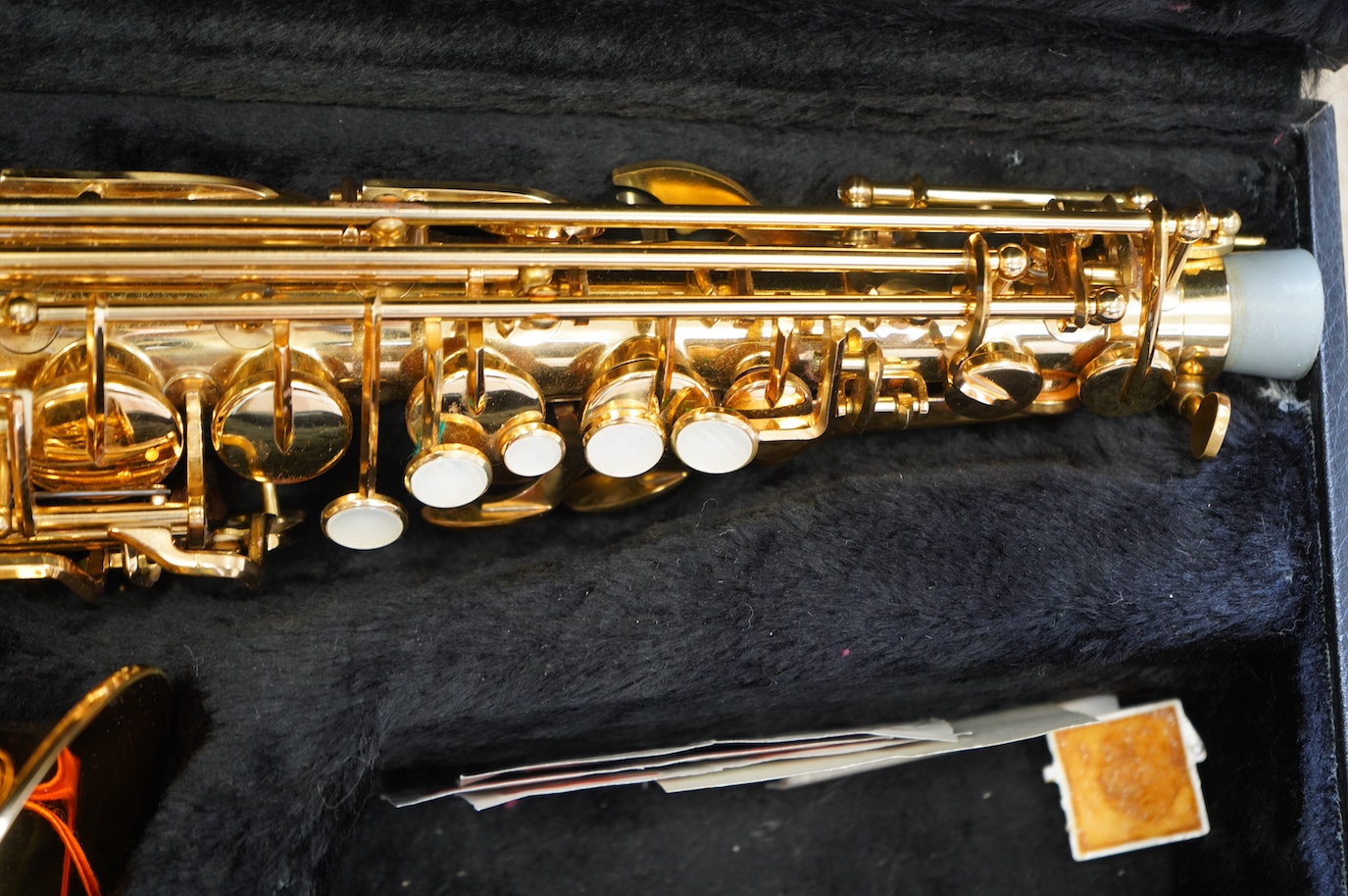 A cased Evette Buffet Crampon brass alto saxophone, together with a saxophone stand. Condition - good